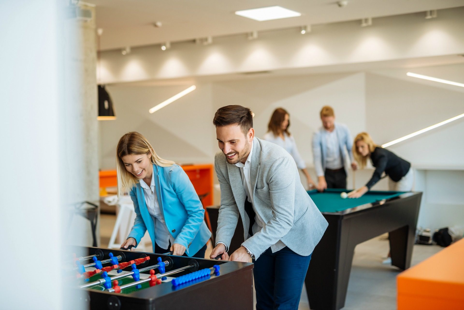 Colleagues playing table football