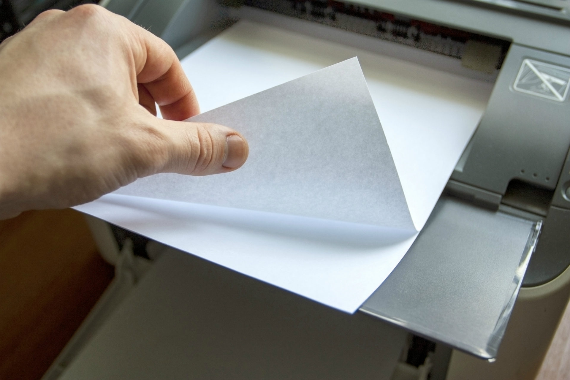 guy removing paper from printer
